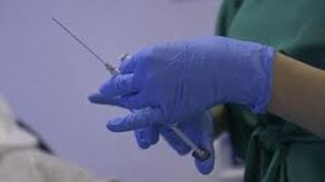 syringe in a doctor's hand